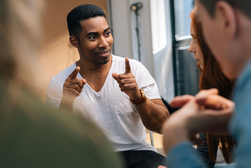 Young man explains the cycle of addiction in a support group for addiction