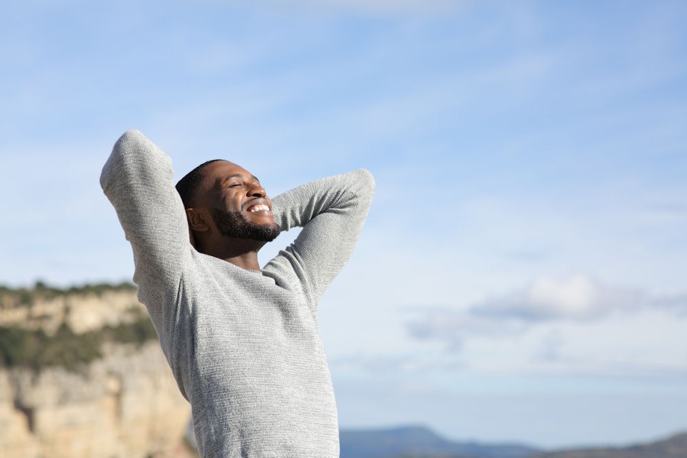 Man enjoying fresh air and freedom, symbolizing recovery and support after addiction treatment